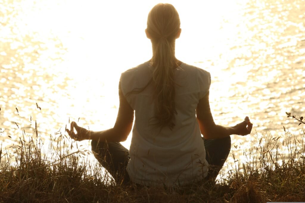 A person meditating in soft light